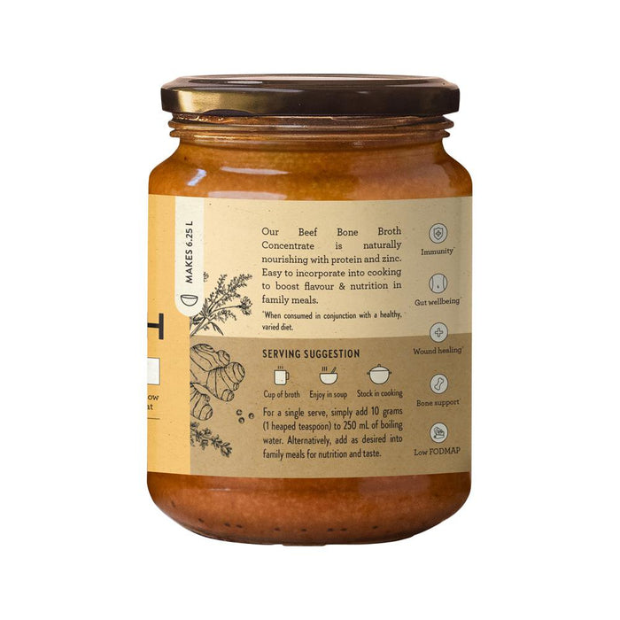 Nutra Organics beef bone broth concentrate with turmeric and ginger in 250g jar, featuring a spoonful of the broth.